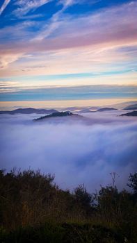 Breathtaking view of clouds over mountains at sunrise in Vila Real, Portugal.