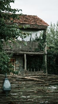 Charming old house with a rustic design surrounded by abundant greenery.