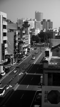 Black and white urban street scene in Tainan City, showing buildings and roadways.