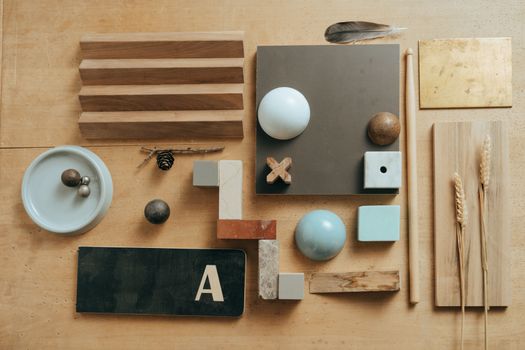 Creative flat lay featuring wooden pieces, geometric shapes, and natural elements on a table.