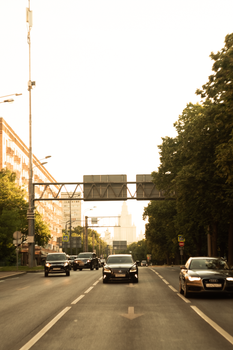 City street with multiple cars under a clear sky, ideal for urban themes.