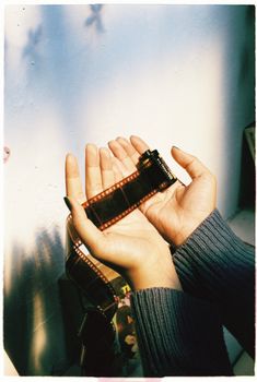 Close-up of hands holding a film strip, capturing a nostalgic moment.