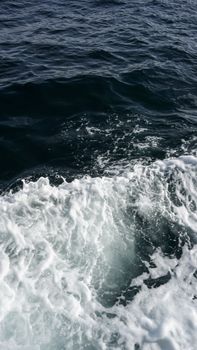 A powerful ocean wave splashes dramatically, showcasing nature's motion and beauty.