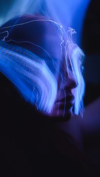 A vibrant abstract neon light portrait capturing movement and emotion.