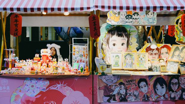 Vibrant market stall showcasing cartoon portraits and handmade crafts, attracting art lovers.