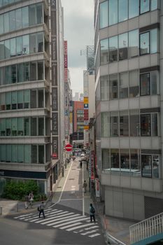 Busy street scene in Tokyo, Japan featuring modern architecture and pedestrians.