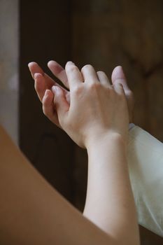 A close-up of two hands gently clasped, symbolizing connection and affection.