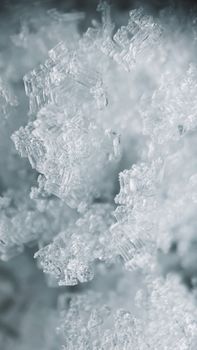 Macro shot of crystalline snow patterns showcasing intricate textures in Olkhonsky District, Russia.